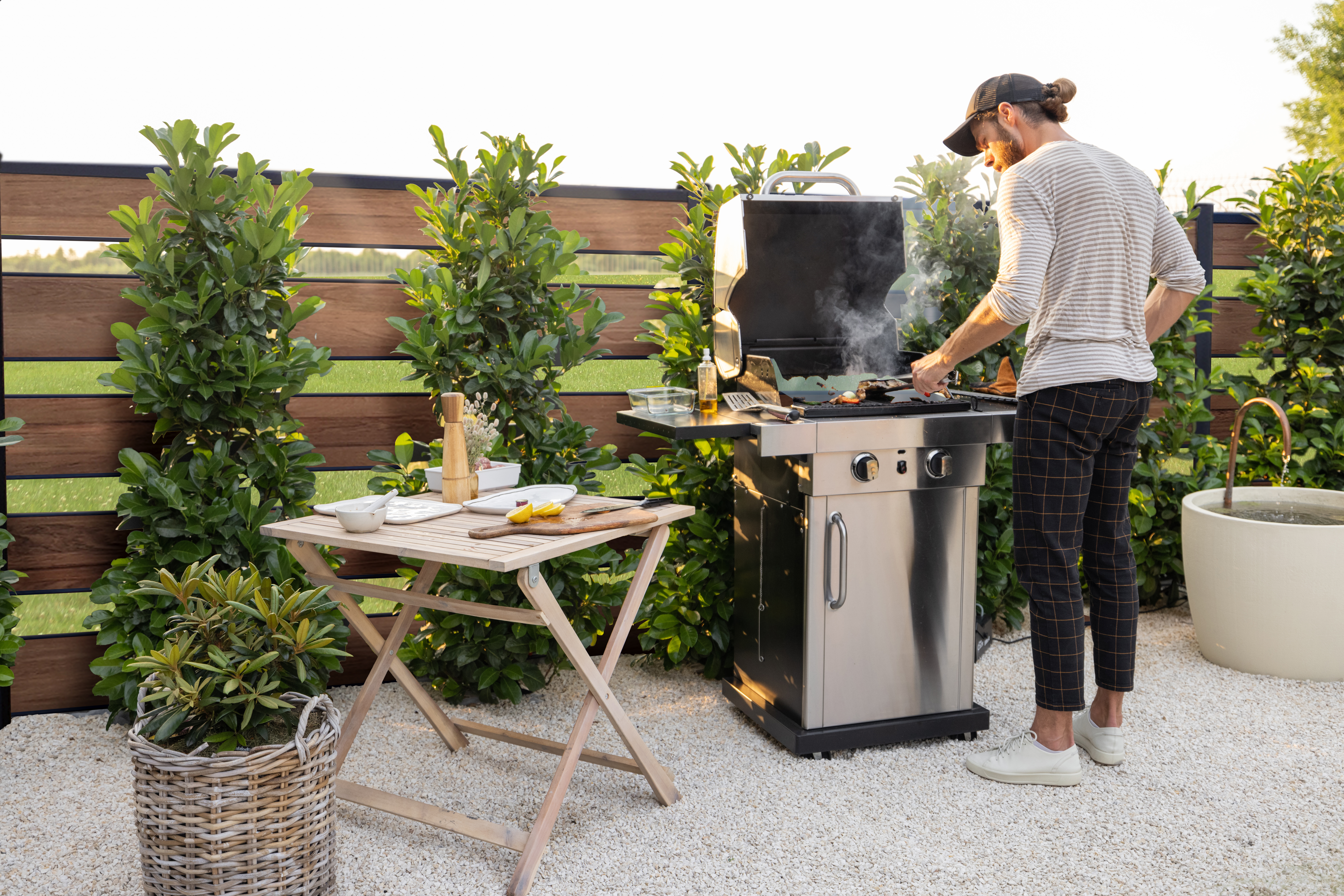 man cooking on a grill outdoors
